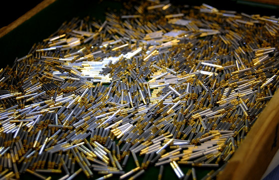 Collection of golden contacts in a container
